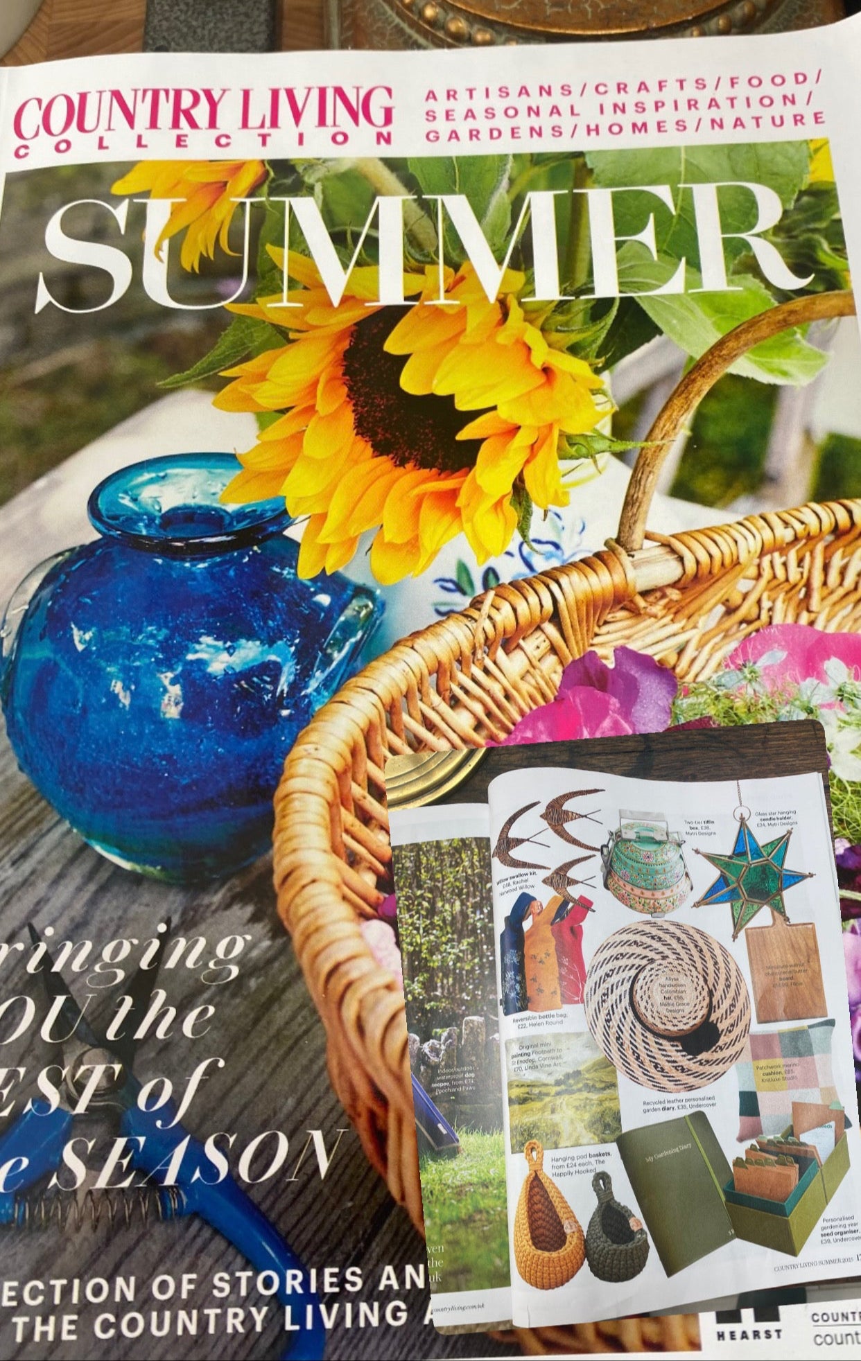 Magazine cover titled 'Summer' from Country Living Collection featuring a sunflower, blue vase, and wicker basket.